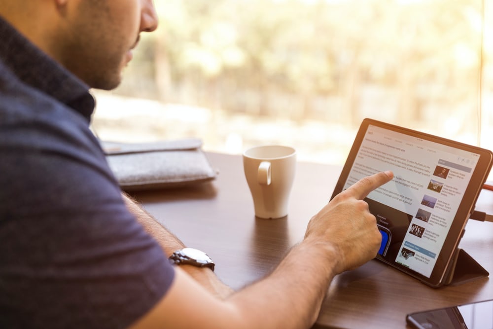 man web surfing on tablet